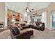 Spacious living room with vaulted ceilings, sliding glass doors, and a seamless flow into the kitchen at 408 Almeria Ct, Winter Springs, FL 32708