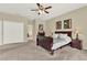 Bright main bedroom with a ceiling fan, neutral colors, and convenient closet and bathroom access at 408 Almeria Ct, Winter Springs, FL 32708