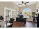 A spacious home office provides an ideal workspace with lots of light and hardwood floors at 408 Almeria Ct, Winter Springs, FL 32708