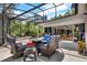 Spacious patio with comfortable seating, a firepit, and access to the screened-in pool at 408 Almeria Ct, Winter Springs, FL 32708