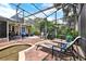 Outdoor patio with a screened pool, spa, seating and lounge chairs, and plenty of greenery at 408 Almeria Ct, Winter Springs, FL 32708