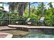 Screened pool area with lush greenery, chaise lounge chairs, and a peaceful atmosphere at 408 Almeria Ct, Winter Springs, FL 32708
