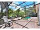 Inviting screened-in pool area with stone patio, lounge chairs, and a rock waterfall at 408 Almeria Ct, Winter Springs, FL 32708