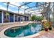 Large backyard pool features a waterfall, screened enclosure, and brick pool deck at 408 Almeria Ct, Winter Springs, FL 32708