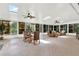 Bright sunroom with skylights, ceiling fans, and comfortable wicker furniture at 408 Almeria Ct, Winter Springs, FL 32708