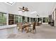 Bright sunroom with tile floors, dining table and chairs, ceiling fans, skylight, and views of the garden at 408 Almeria Ct, Winter Springs, FL 32708