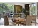 Dining table and chair set in the sunroom with scenic backyard views at 408 Almeria Ct, Winter Springs, FL 32708
