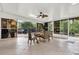 Sunroom with a dining table and views to the outdoor patio, backyard, and swimming pool at 408 Almeria Ct, Winter Springs, FL 32708