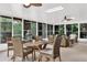Sunroom dining and living area with tile floors, furniture, a dining table and lovely backyard views at 408 Almeria Ct, Winter Springs, FL 32708