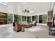 Inviting sunroom featuring tile floors, wicker seating, and panoramic views of the outdoors at 408 Almeria Ct, Winter Springs, FL 32708