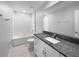 Bathroom featuring tiled floors, granite countertops, a large mirror, and a shower-tub combo at 4346 Trotters Way, Lakeland, FL 33801