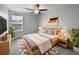 Cozy bedroom featuring a ceiling fan, natural light, and a comfortable queen bed at 4346 Trotters Way, Lakeland, FL 33801