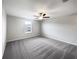Large bedroom features soft carpet, a ceiling fan, and a bright window at 4346 Trotters Way, Lakeland, FL 33801