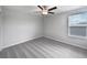 The bedroom features soft carpet, a ceiling fan, and a window for ample natural light at 4346 Trotters Way, Lakeland, FL 33801