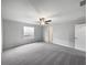 Comfortable carpeted bedroom with a ceiling fan and natural light from the window at 4346 Trotters Way, Lakeland, FL 33801