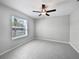 An inviting bedroom features a ceiling fan and a window offering natural light at 4346 Trotters Way, Lakeland, FL 33801