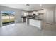 Modern eat-in kitchen with stainless steel appliances, granite countertops, and white cabinets, and tile floors at 4346 Trotters Way, Lakeland, FL 33801