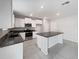Modern kitchen with stainless steel appliances, granite countertops, and a large island at 4346 Trotters Way, Lakeland, FL 33801