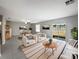Bright living room featuring neutral tones, large windows, and modern furniture with a dining area at 4346 Trotters Way, Lakeland, FL 33801