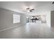 Open-concept living room with tile flooring leading into a modern kitchen with stainless steel appliances at 4346 Trotters Way, Lakeland, FL 33801