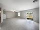 Spacious, bright living area featuring tile flooring and sliding glass doors to the backyard at 4346 Trotters Way, Lakeland, FL 33801