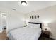 Cozy bedroom with a queen bed, wood floors, adjacent to a bathroom at 4461 Summer Flowers Pl, Kissimmee, FL 34746