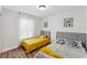 Cozy bedroom showcasing two beds with gray headboards, contrasting pillows and throws, and modern art on the walls at 4461 Summer Flowers Pl, Kissimmee, FL 34746