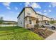 A well-maintained townhouse boasts a lush lawn and a brick-paved driveway leading to the garage at 4461 Summer Flowers Pl, Kissimmee, FL 34746