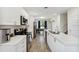 Modern kitchen featuring stainless steel appliances, white cabinetry, and a breakfast bar island at 4461 Summer Flowers Pl, Kissimmee, FL 34746