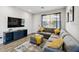 Comfortable living room with a gray sectional, TV, and wood-look flooring at 4461 Summer Flowers Pl, Kissimmee, FL 34746
