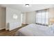Beautifully staged main bedroom with natural light, wood flooring and neutral colored walls at 4461 Summer Flowers Pl, Kissimmee, FL 34746