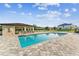 Beautiful community pool with a covered pavilion and ample seating on a sunny day at 4461 Summer Flowers Pl, Kissimmee, FL 34746