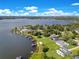 An aerial view of luxurious waterfront homes, showcasing private docks and beautifully landscaped yards at 49 Interlaken Rd, Orlando, FL 32804