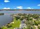 Stunning aerial view of lakefront homes with private docks and lush green lawns under a bright blue sky at 49 Interlaken Rd, Orlando, FL 32804