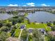Aerial view of waterfront homes with large yards, private docks, and lush landscaping on a sunny day at 49 Interlaken Rd, Orlando, FL 32804