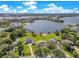 Aerial view featuring waterfront homes with green lawns, private docks, and scenic lake views at 49 Interlaken Rd, Orlando, FL 32804