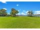 Vast backyard with a meticulously maintained lawn, bordered by a black fence, with lake access at 49 Interlaken Rd, Orlando, FL 32804