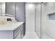 Bathroom with gray vanity, modern sink, and shower with glass doors at 49 Interlaken Rd, Orlando, FL 32804