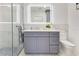 Modern bathroom with light gray vanity, marble wall tiles, and glass-enclosed shower at 49 Interlaken Rd, Orlando, FL 32804