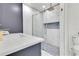 Modern bathroom with a glass shower, featuring a rain shower head and a stone-tiled floor at 49 Interlaken Rd, Orlando, FL 32804