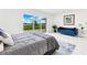 Bright bedroom with a lake view through sliding glass doors, and a plush blue sofa at 49 Interlaken Rd, Orlando, FL 32804
