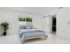 Clean bedroom with a large window, modern sliding closet doors, and a light wood frame bed at 49 Interlaken Rd, Orlando, FL 32804