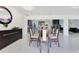 The formal dining room features a glass-top table and modern decor, flowing seamlessly into the open-concept layout at 49 Interlaken Rd, Orlando, FL 32804