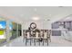 Bright dining room with marble flooring, modern decor, and easy access to the outdoor kitchen at 49 Interlaken Rd, Orlando, FL 32804
