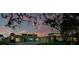 A gorgeous single-story home with a three-car garage, a circular driveway, and manicured landscaping at 49 Interlaken Rd, Orlando, FL 32804