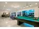 Bright game room featuring a pool table, modern lighting, easy access to kitchen, living and dining areas at 49 Interlaken Rd, Orlando, FL 32804