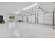 Spacious three-car garage with finished floors, ample lighting and a side utility door at 49 Interlaken Rd, Orlando, FL 32804