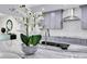 Close-up of a modern kitchen with marble countertops and stainless steel sink and gray cabinets at 49 Interlaken Rd, Orlando, FL 32804