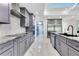 Contemporary kitchen with gray cabinets, stainless steel appliances, and marble countertops at 49 Interlaken Rd, Orlando, FL 32804