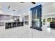 Stylish living area showcasing a contemporary wine rack, marble floors, and open flow to the gourmet kitchen at 49 Interlaken Rd, Orlando, FL 32804